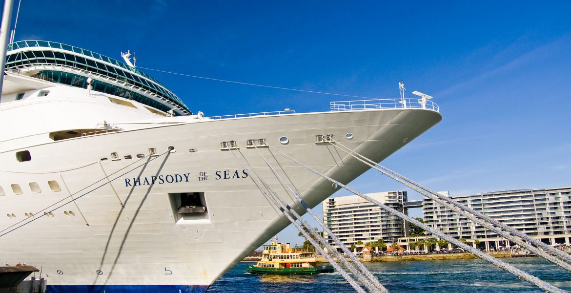 Commercial Photography: Boats and Ships Free Stock Photos. The stern of a large cruise ship, the 'Rhapsody of the Seas,' docked in Sydney, Australia, at the Circular Quay, near the Sydney Opera House and the Sydney Harbour Bridge.