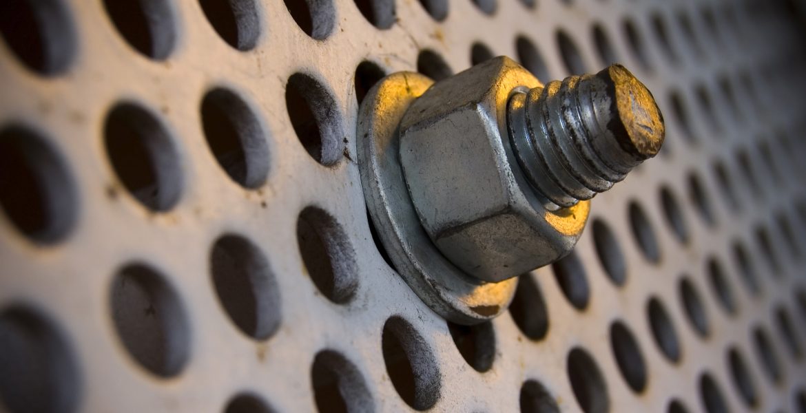 Industrial Photography: Free Stock Photo Downloads. A close-up image of a bolt on a large, industrial screw.