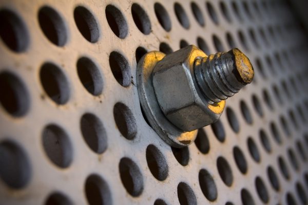 Industrial Photography: Free Stock Photo Downloads. A close-up image of a bolt on a large, industrial screw.