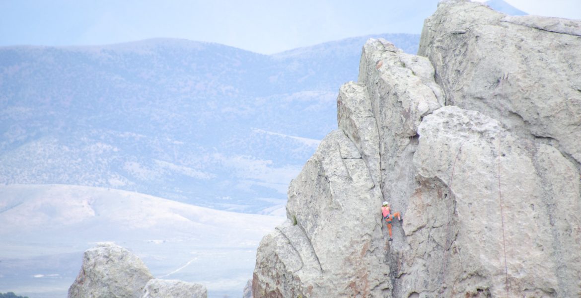 Idaho National Parks - City of Rocks National Reserve. A rock climber ascends a vertical rock face in the center of the City of Rocks and Idaho's Castle Rocks State Park.