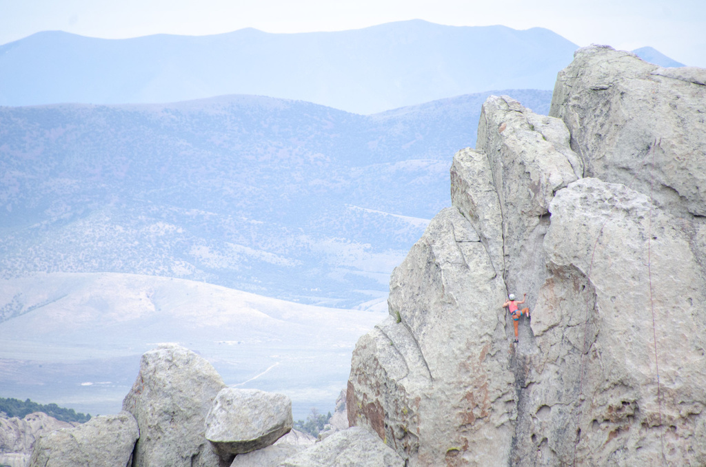 City of Rocks - Climbing Hiking Camping. A climber ascends a vertical rock face in Idaho's City of Rocks National Reserve.